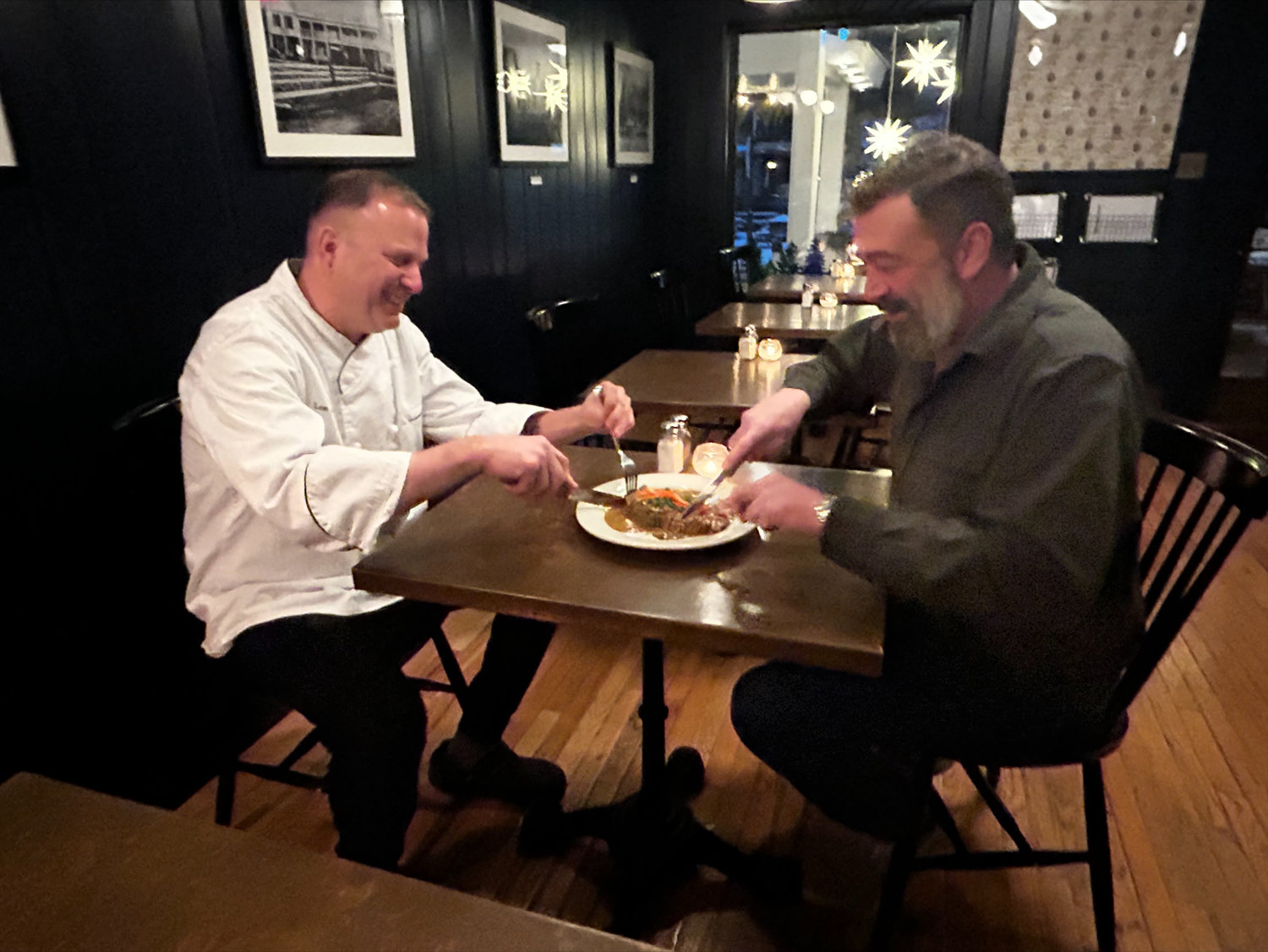 The Andes Hotel owner Derek Curl and Kivell share a meal.